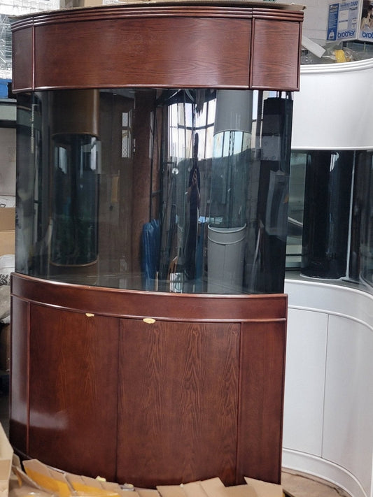 Large wooden aquarium with glass front in a room setting