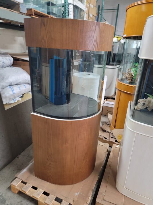 Wooden cylindrical aquarium on a pallet in a warehouse setting