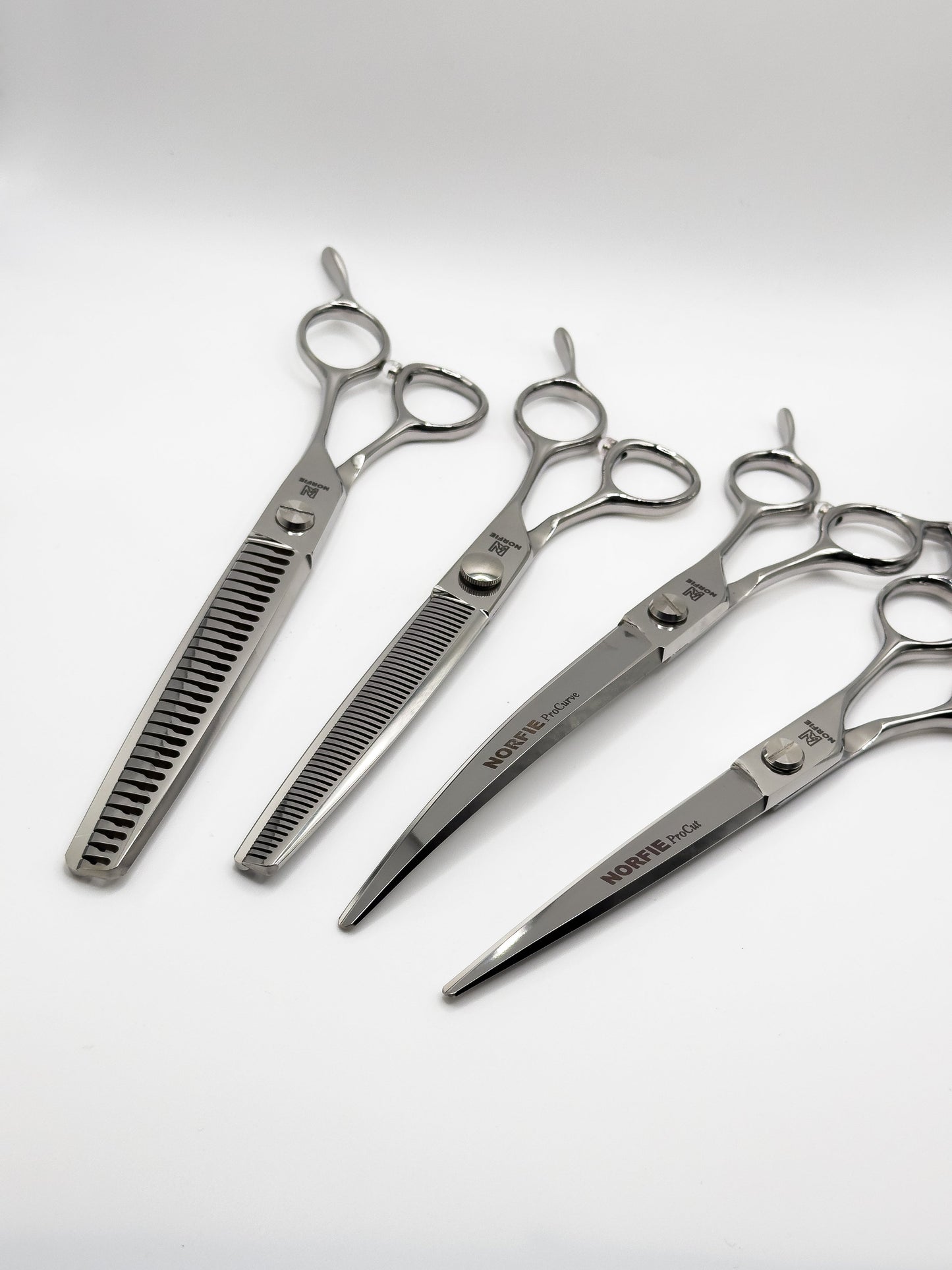Set of four pairs of scissors on a white background