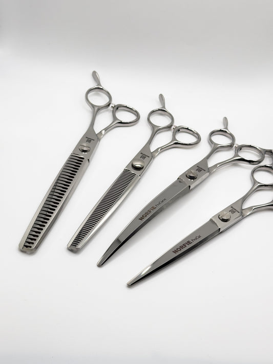 Set of four pairs of scissors on a white background