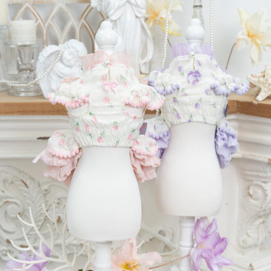 Decorative vases with floral arrangements on a decorative shelf.