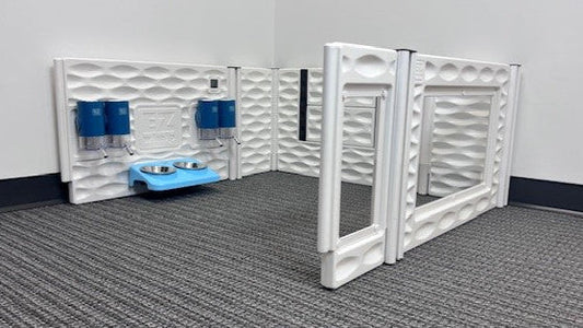 Pet playpen with water bowls and leashes on a gray floor.
