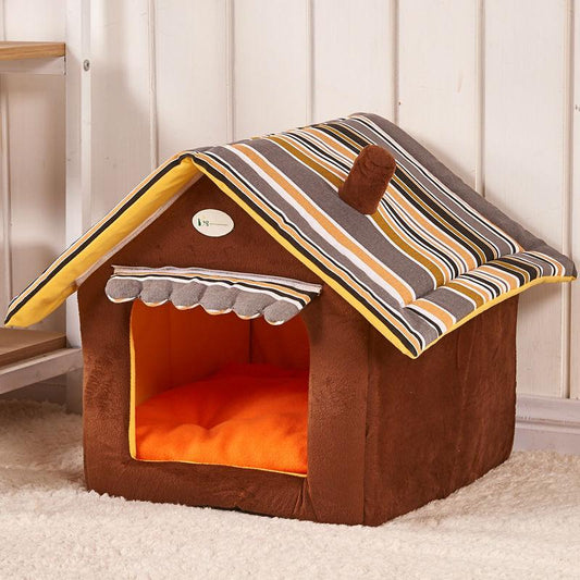 Brown pet house with striped roof and orange interior on a carpeted floor.