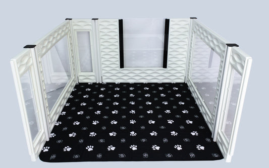Pet playpen with a black mat featuring paw prints on a white background