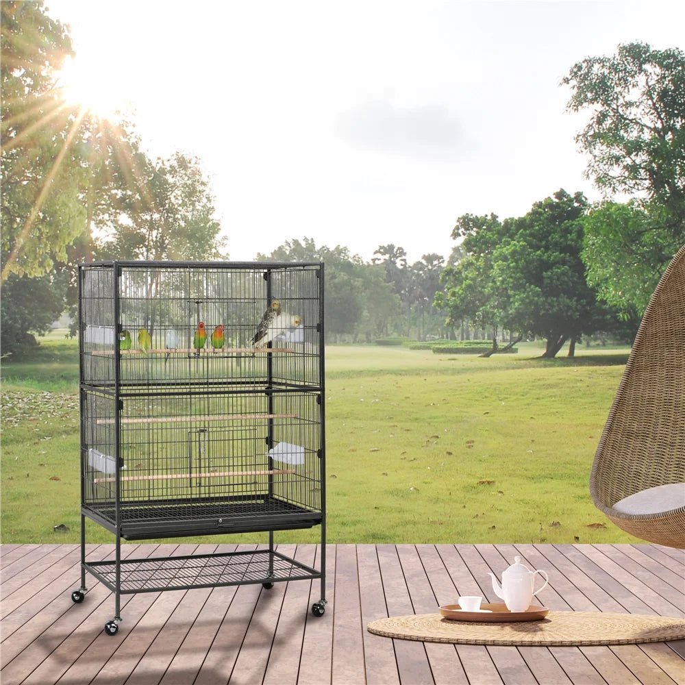 Large bird cage on a wooden deck with a scenic background of trees and grass.