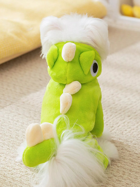 Green plush toy with white accents on a beige surface