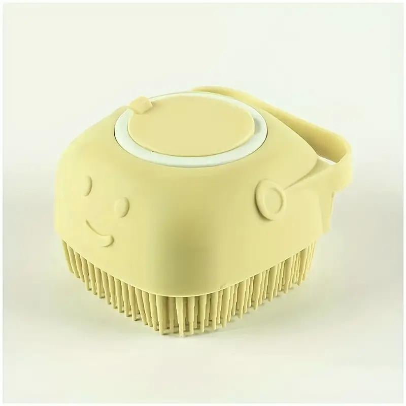 Yellow silicone pet grooming brush with soft bristles and ergonomic handle for dogs and cats.