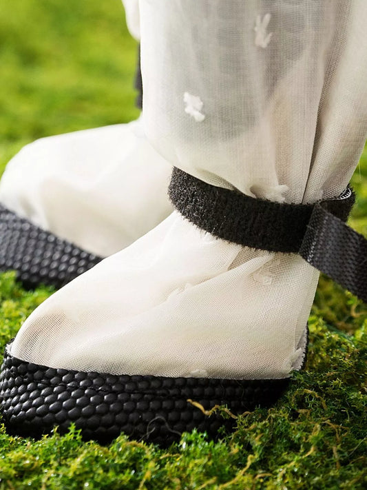 White shoes with black straps on grass