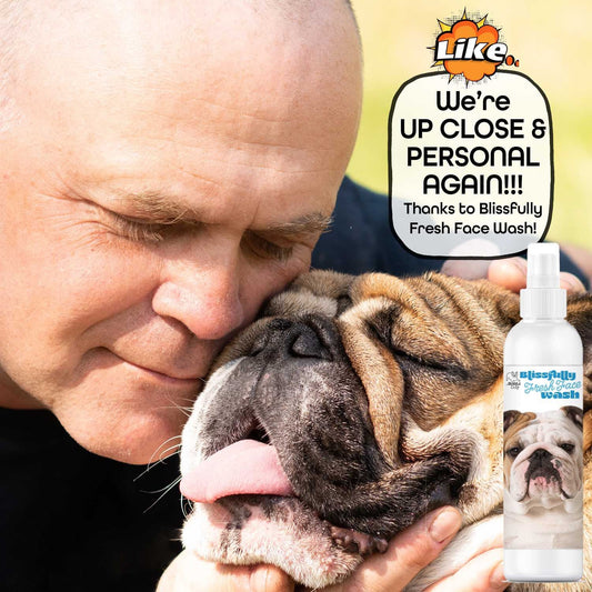 Man hugging a dog with a bottle of Blissfully Fresh Face Wash in the corner.