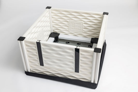 White pet crate with black straps on a white background