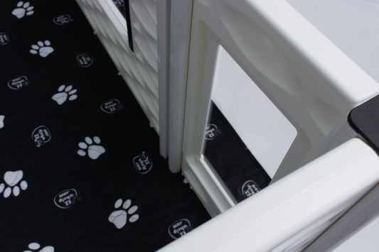 Black mat with white paw prints on a white surface