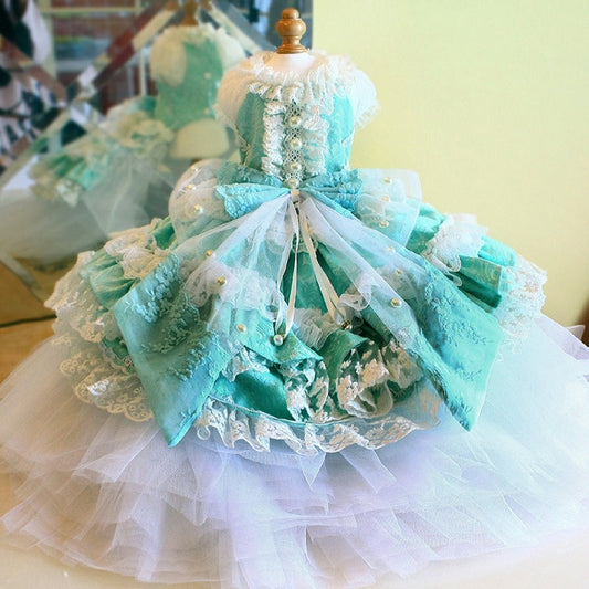 Turquoise and white lace dress on a mannequin against a blurred indoor background