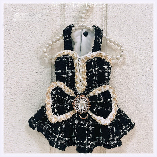 Black and white checkered dress with a large bow on a textured white background