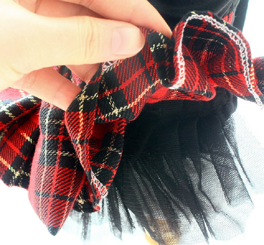 Close-up of a red and black plaid fabric with a blurred background