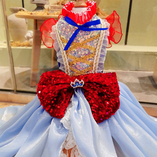 Decorative dress with red and blue bow and white embellishments in a store setting