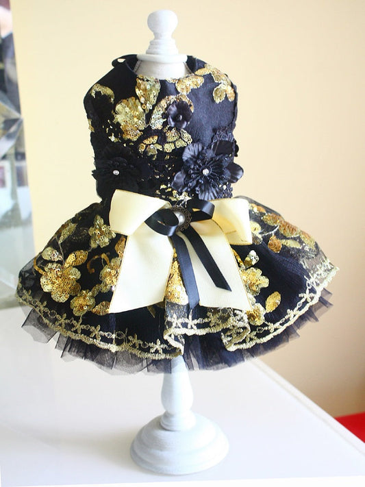 Navy and gold floral dress on a mannequin with a white background