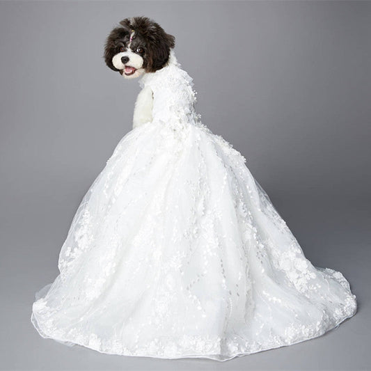 Dog wearing a white wedding dress on a gray background