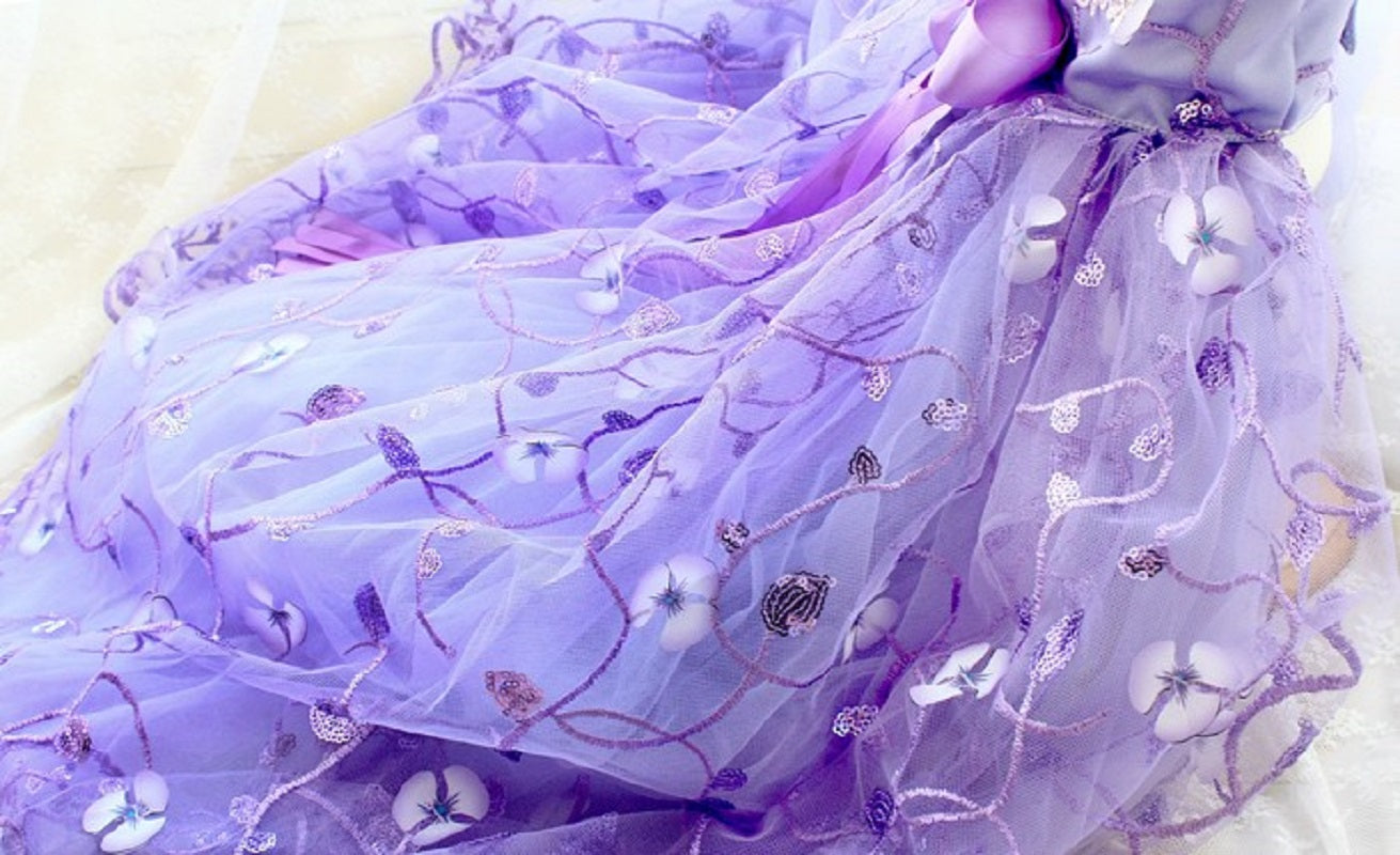 Purple dress with floral embroidery on a white background
