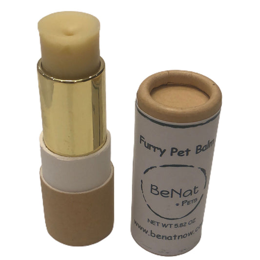 Furry pet balm with gold cap and brown container on a white background