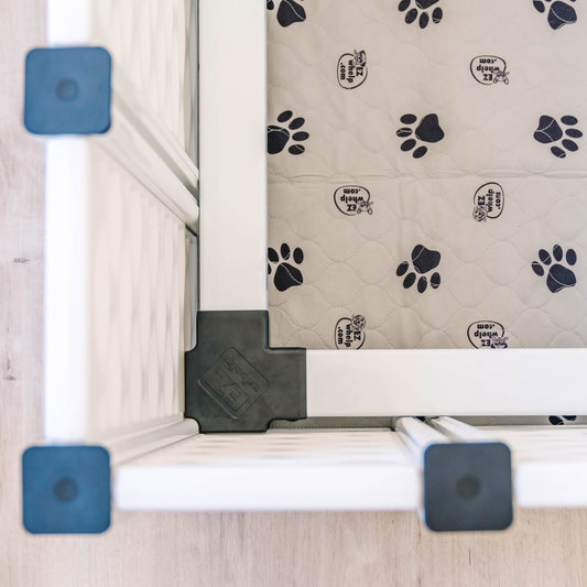 Pet gate with a paw print patterned mat on a wooden floor