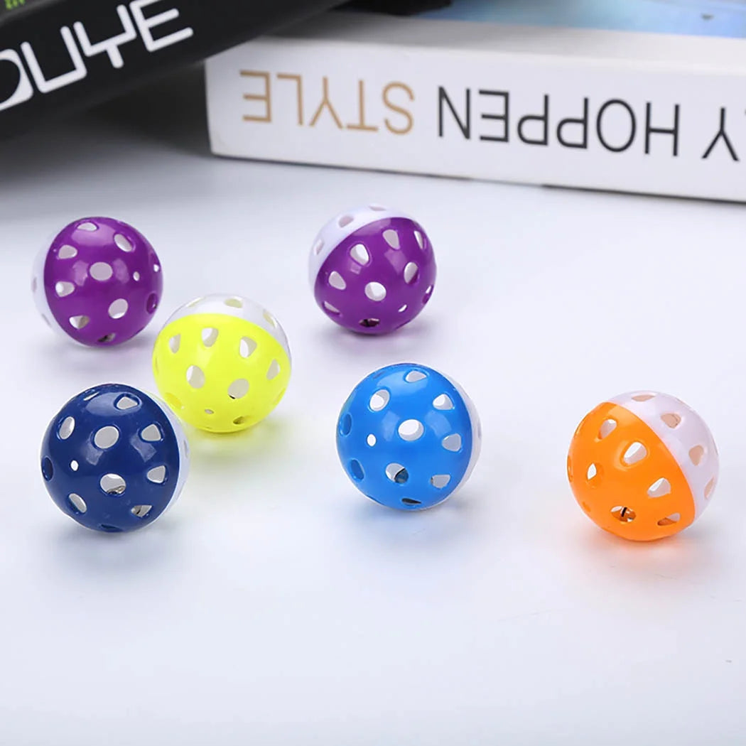 6 Colorful Plastic Balls with Holes, on a white surface.