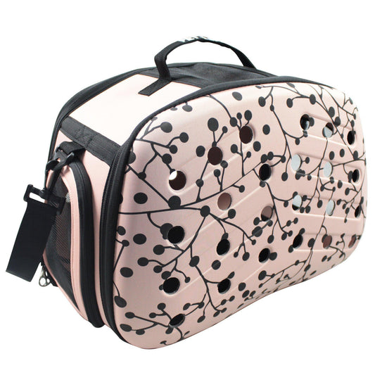 Pink pet carrier with black floral pattern on a white background