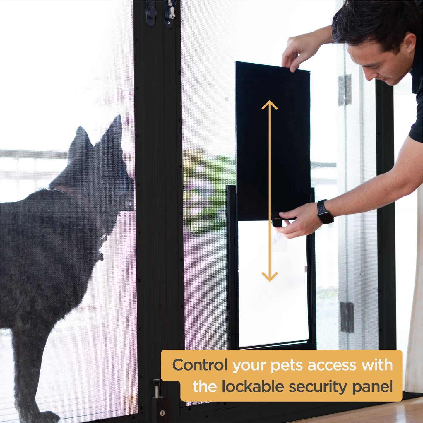 Person using a lockable security panel for a pet door with a Dog on the other side.