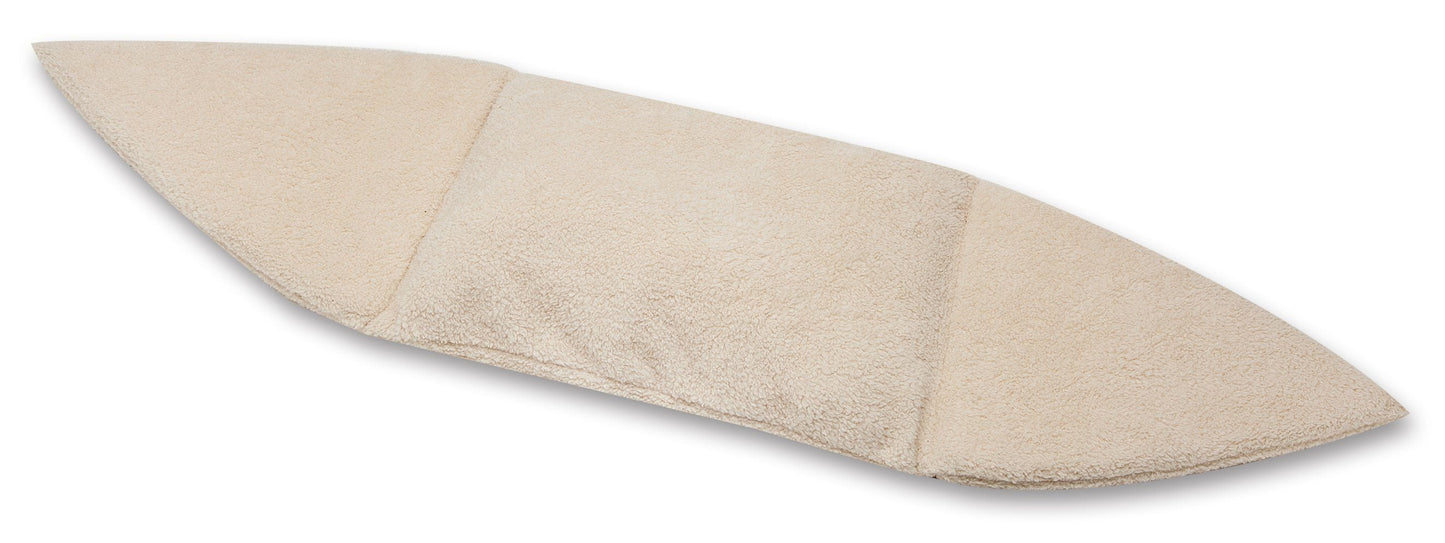 Beige surfboard-shaped bath mat on a white background