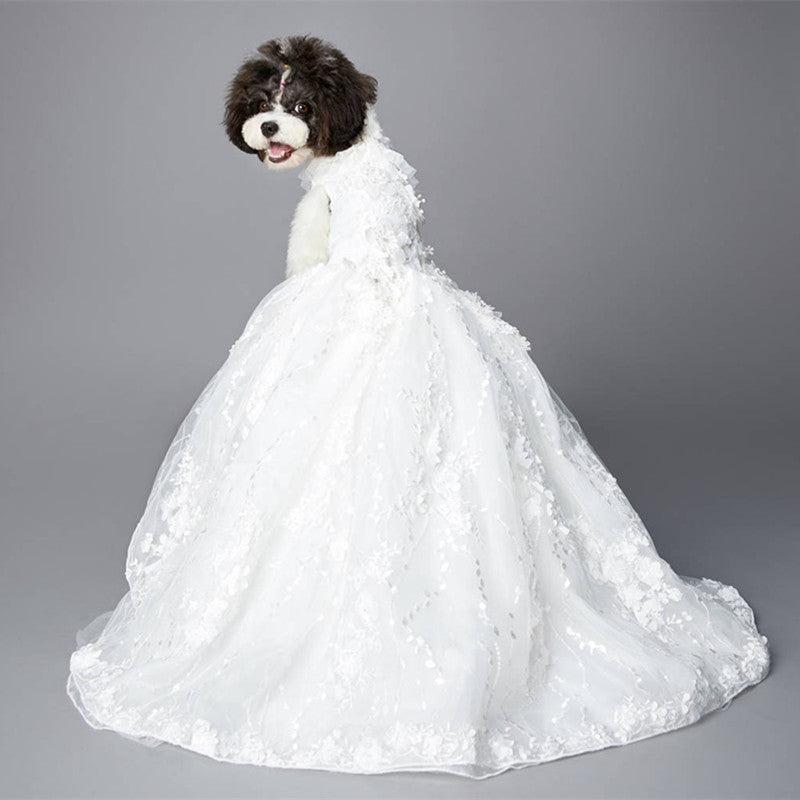 Dog wearing a gorgeous white wedding gown on a gray gradient background