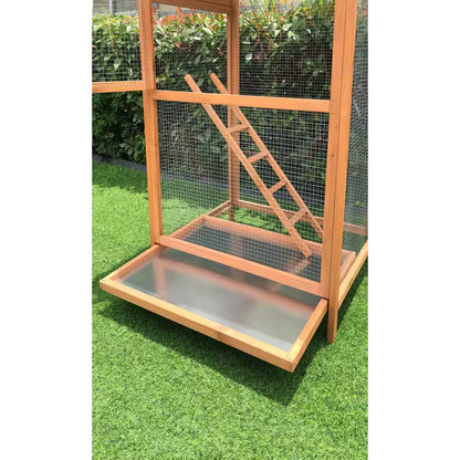 Wooden pet cage with a ramp on a grassy surface