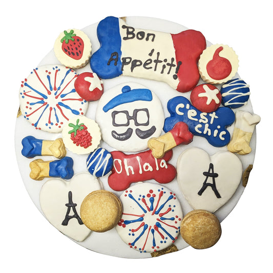 Decorative plate with French-themed cookies on a white background