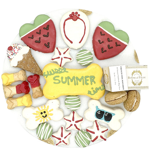 Assorted dog cookies with summer-themed designs on a white background