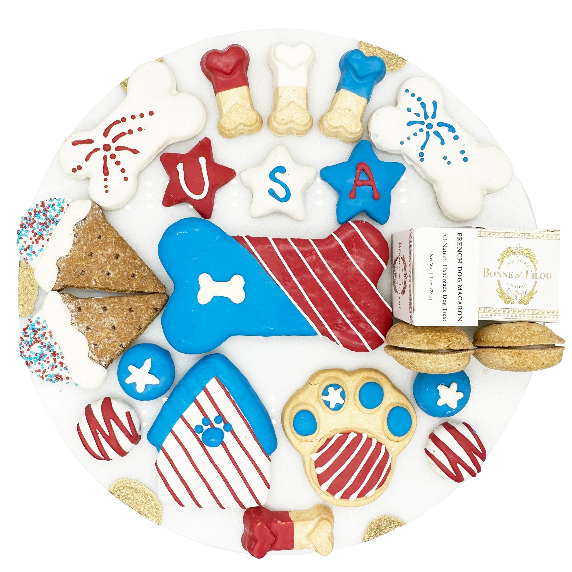 Assorted dog treats shaped like bones, stars, and paw prints with a 'USA' design on a white background.