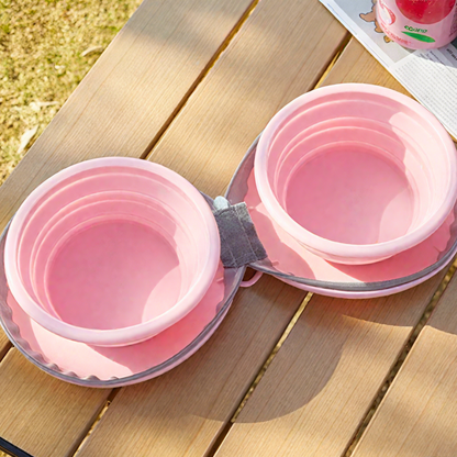 Pink collapsible bowls on a wooden surface