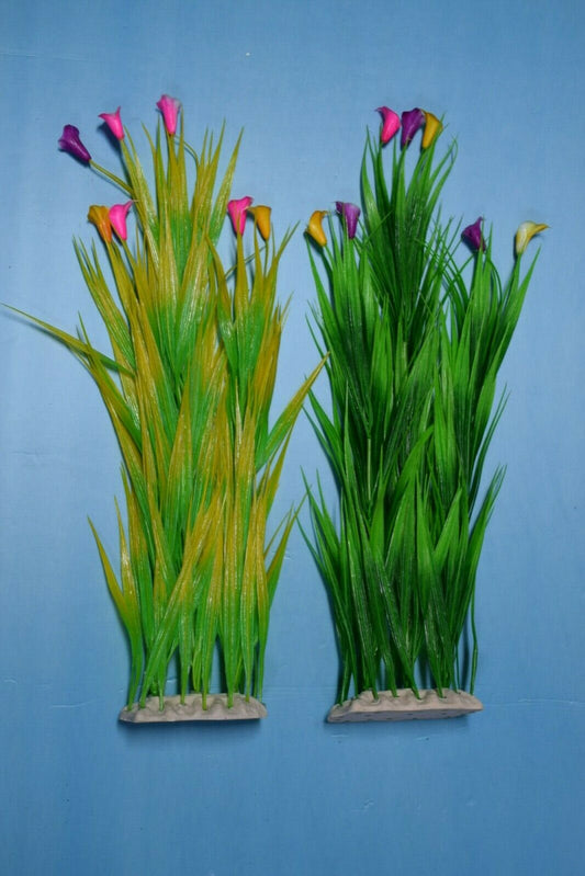Two artificial aquarium plants with green leaves and colorful flowers on a blue background