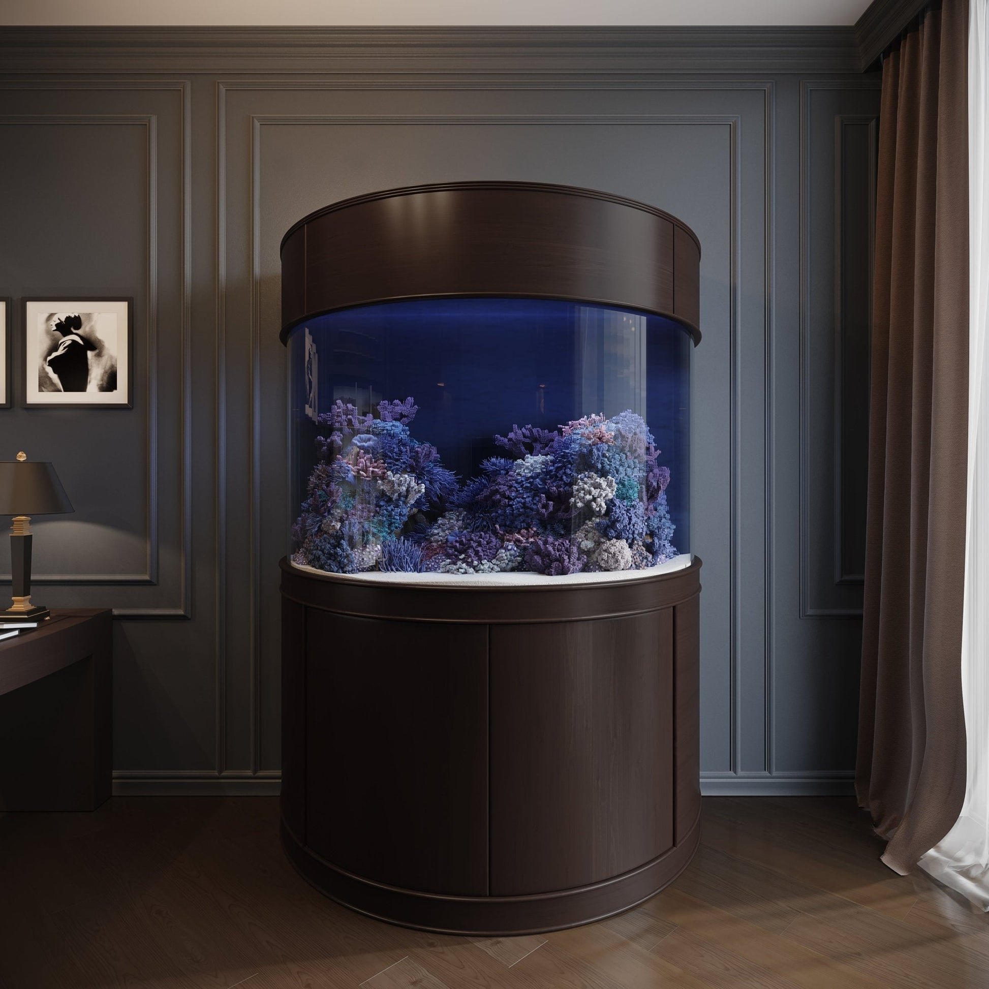 Round aquarium with underwater scenery in a room with dark walls and a lamp.