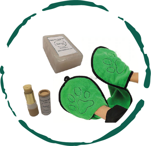 Green pet grooming mitts with a box and bottles on a white background