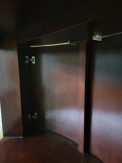 Wooden wardrobe with two doors in a dimly lit room