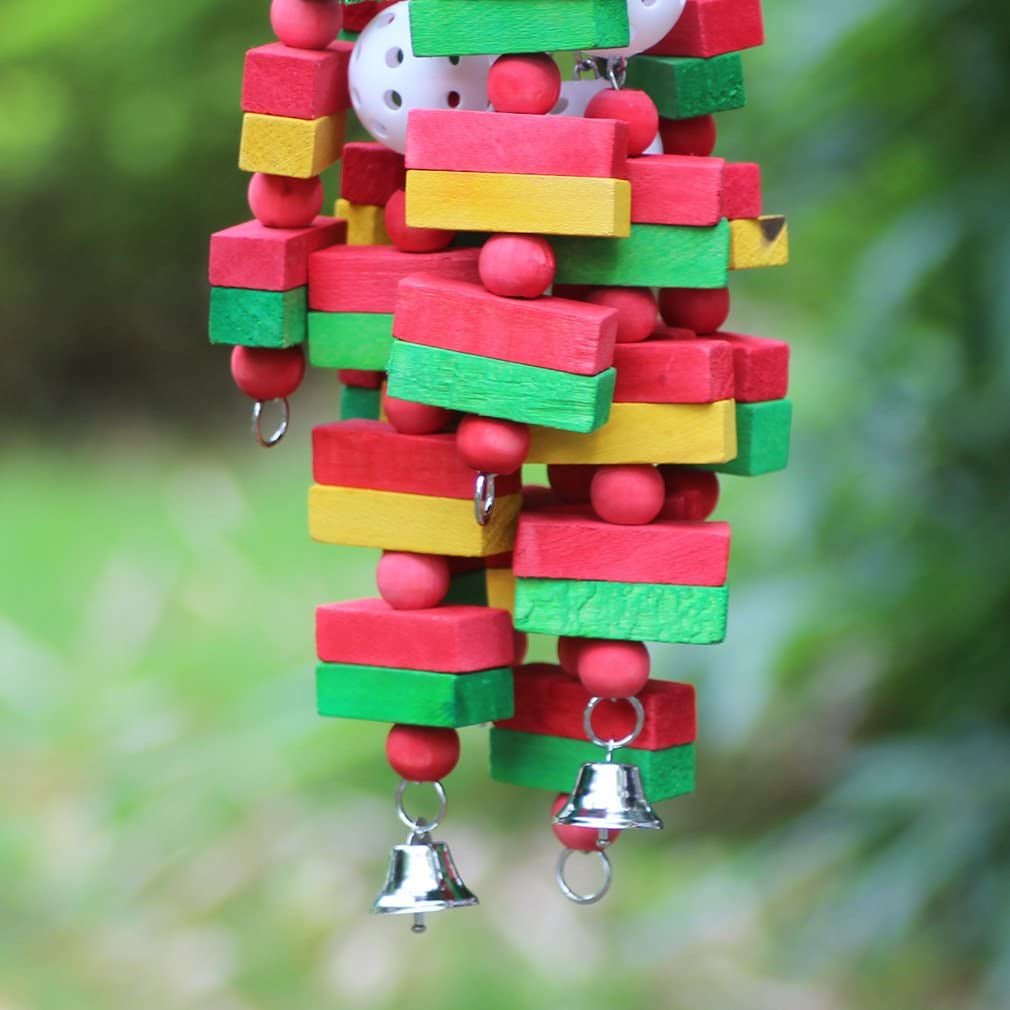 Colorful wooden bird toy with bells against a green blurred background