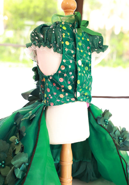 Green floral dress on a mannequin with a blurred outdoor background