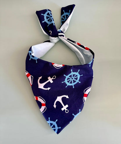 Nautical-themed bandana with anchors and ship wheels on a plain background