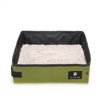 Pet litter box with green base and black lid on a white background