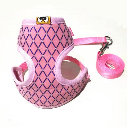 Pink and purple patterned dog harness with matching leash on a white background