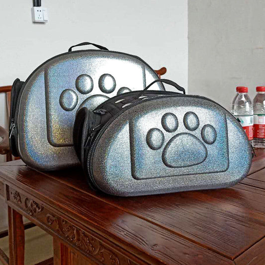 Two glittery pet carriers with paw prints on a wooden table.