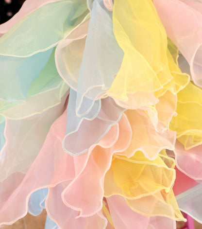 Close-up of colorful ruffled fabric with pastel shades.
