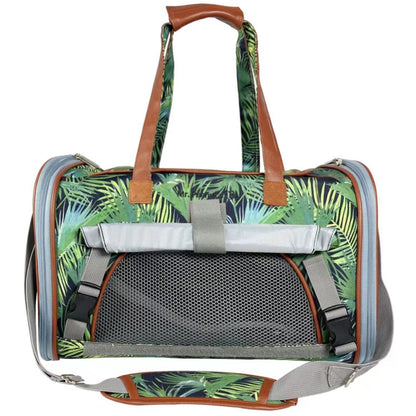 Pet carrier with tropical leaf pattern and brown handles on a white background