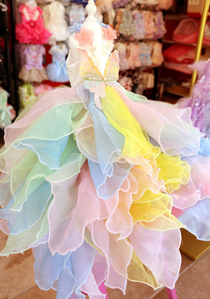 Pastel-colored dress with ruffled layers in a store setting