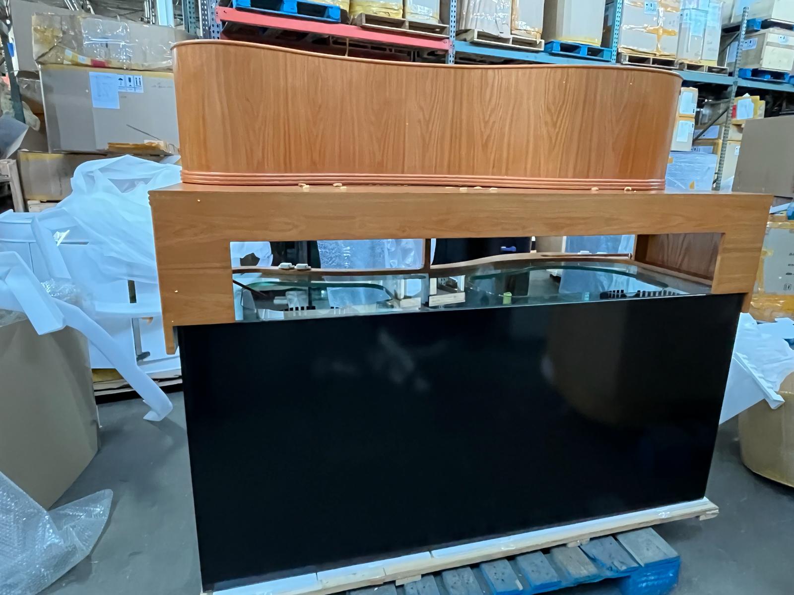 Wooden counter with glass front on a pallet in an indoor setting