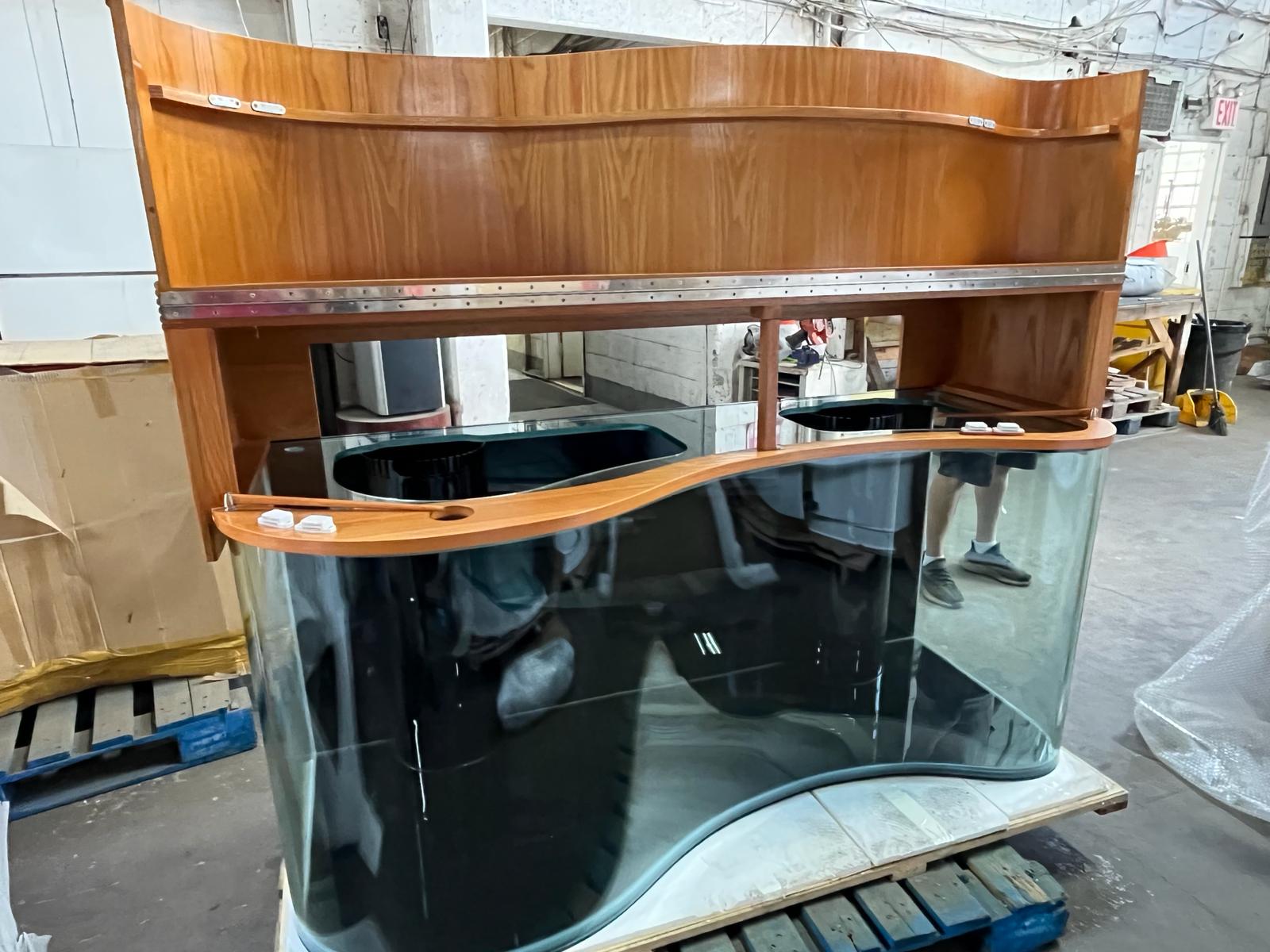 Wooden and glass aquarium on a pallet in an indoor setting