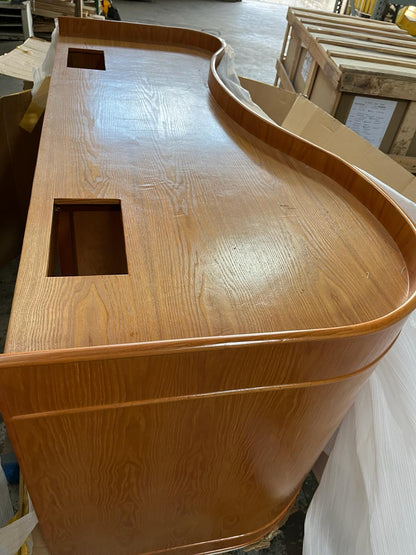 Wooden counter with curved design in a workshop setting